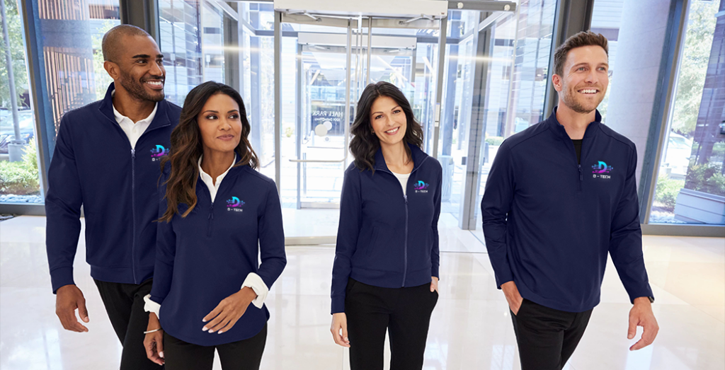 Business professionals in custom corporate apparel by Big Frog, standing in a hallway.